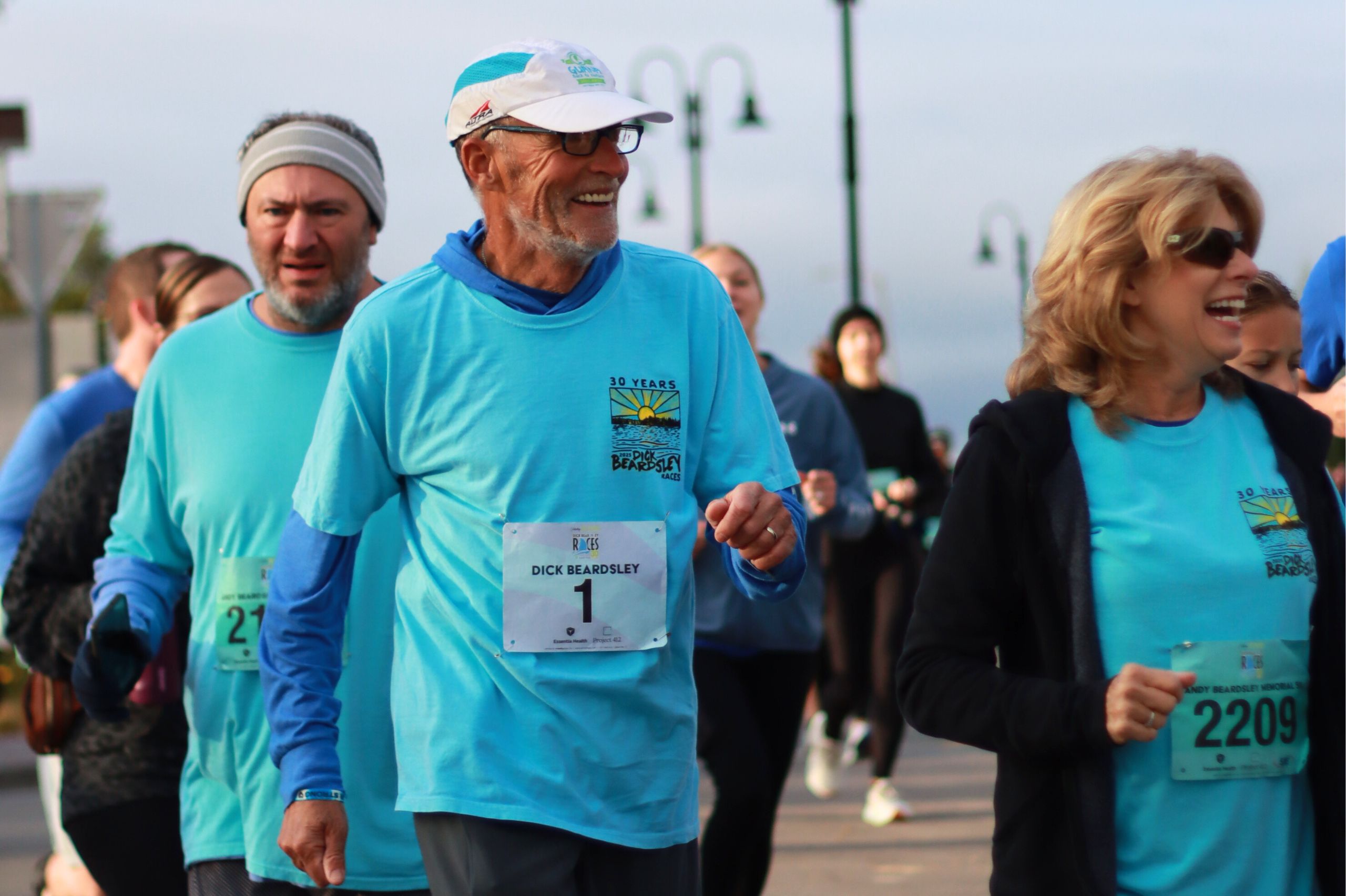 Happy men (Dick Beardsley) and a woman wearing race t-shirts