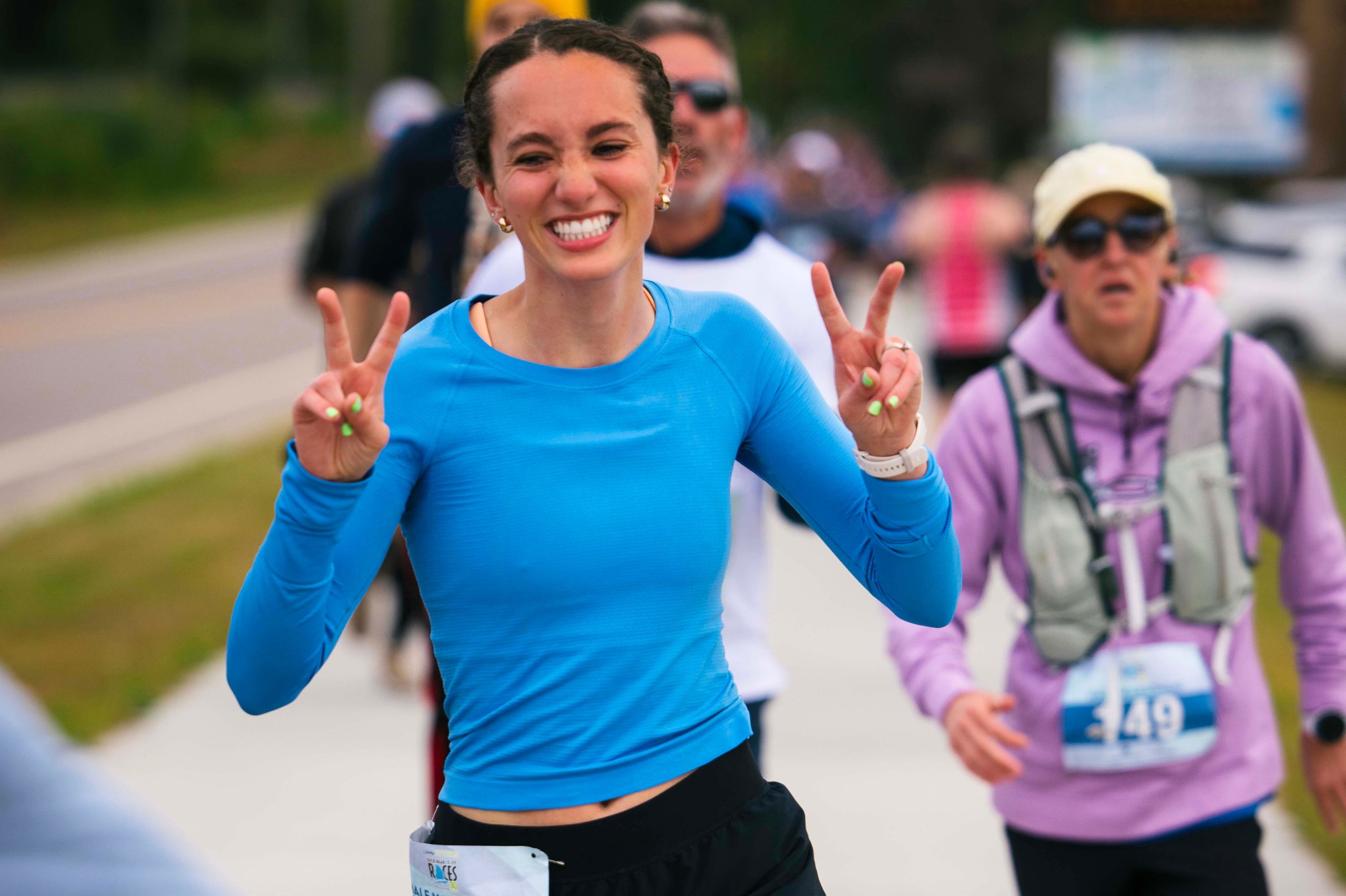a joyous female runner smiling brightly for the camera